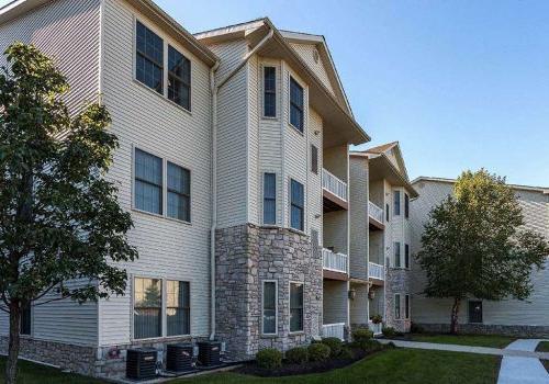 Exterior view of residential buildings at The Enclaves at Packer Park apartments for rent