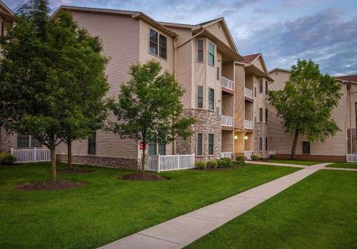 Exterior view of residential buildings at The Enclaves at Packer Park apartments for rent